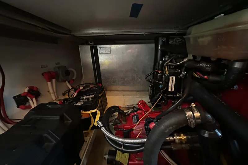 Slide: The Image of Engine room of a 2005 Carver 36 Super Sport boat, showing mechanical components. - 58