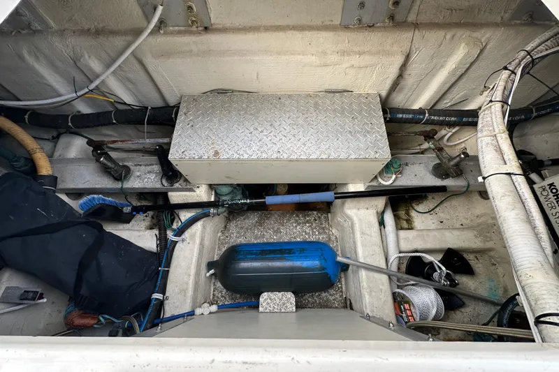 Slide: The Image of Engine compartment of a 2005 Carver 36 Super Sport boat, showing various mechanical components. - 61