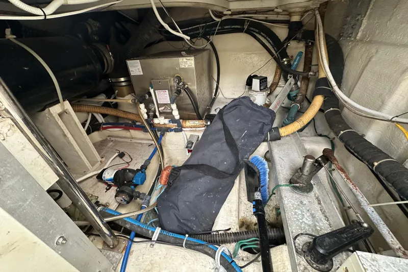 Slide: The Image of Engine room of a 2005 Carver 36 Super Sport boat with various mechanical components. - 62
