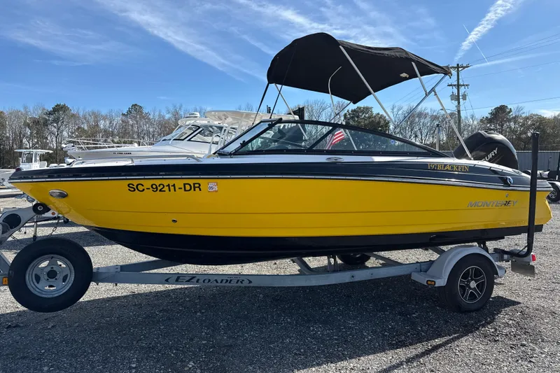 The Image of Yellow 2014 Monterey 197 Blackfin boat on trailer, parked outdoors under blue sky. - 0
