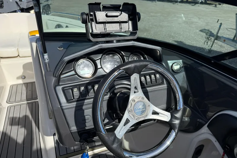 Slide: The Image of Steering console of a 2014 Monterey 197 Blackfin boat with gauges and controls. - 12