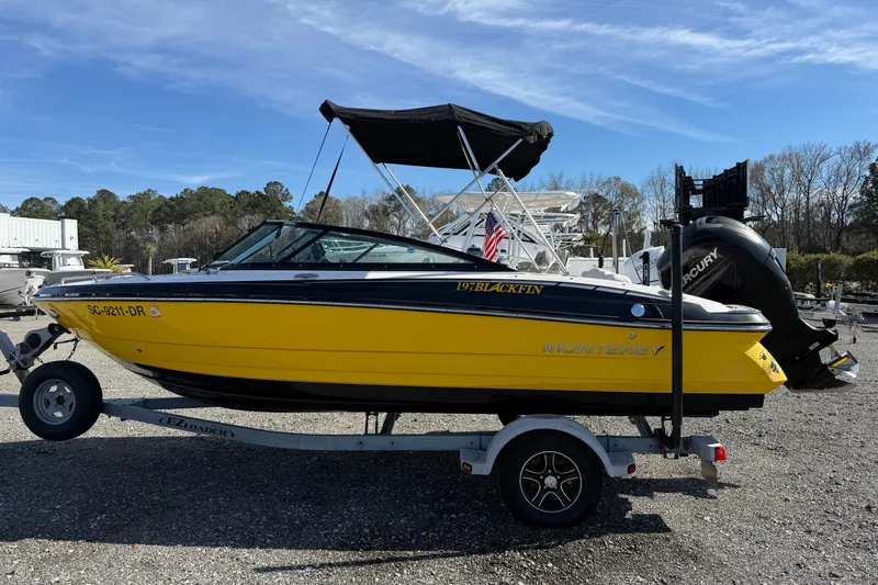 Slide: The Image of 2014 Monterey 197 Blackfin boat on trailer, vibrant yellow hull, outdoor setting. - 2