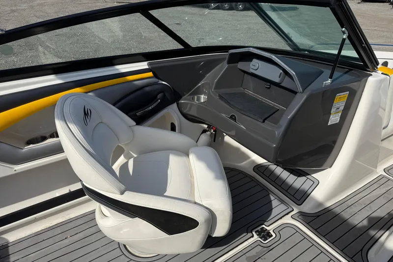 Slide: The Image of 2014 Monterey 197 Blackfin boat interior with white captain's chair and dashboard. - 21
