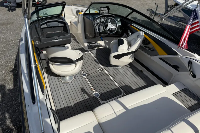 Slide: The Image of 2014 Monterey 197 Blackfin boat interior with seating and steering wheel, featuring American flag. - 23