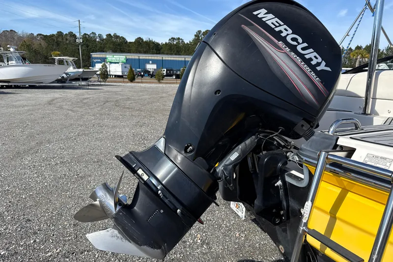 Slide: The Image of Outboard motor on a 2014 Monterey 197 Blackfin boat in a marina setting. - 27