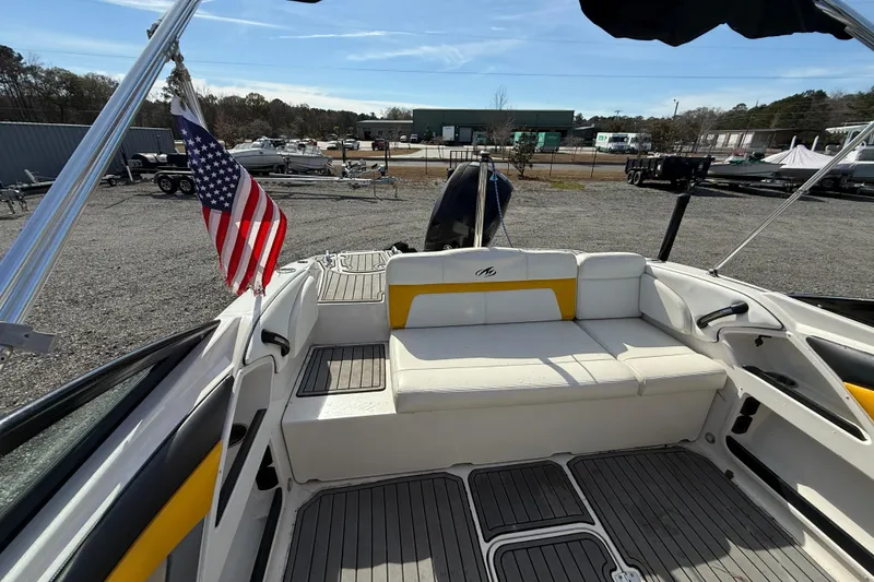 Slide: The Image of 2014 Monterey 197 Blackfin boat interior with American flag, docked outdoors. - 9