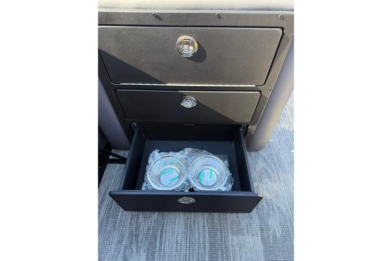 Slide: The Image of Open drawer in 2026 Viaggio X22Q, containing packaged items on a carpeted floor. - 12