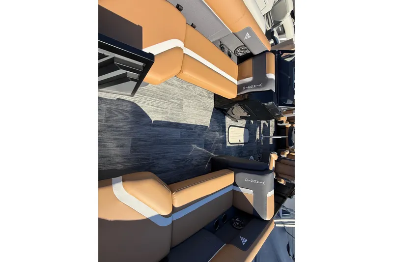 Slide: The Image of Luxurious interior of 2026 Viaggio X22Q pontoon boat with tan and gray seating. - 17