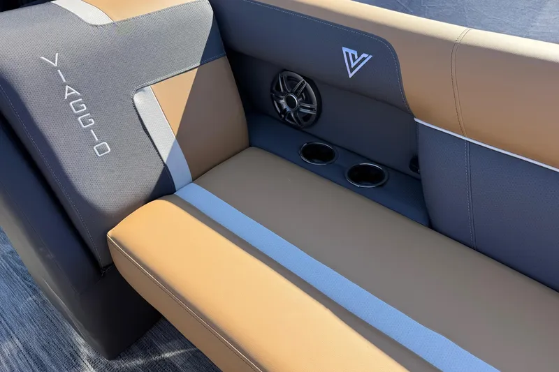 Slide: The Image of Viaggio X22Q 2026 boat interior with tan and gray seating, cup holders, and speaker. - 20
