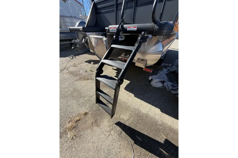 Slide: The Image of Rear view of 2026 Viaggio X22Q boat with foldable ladder on pavement. - 31