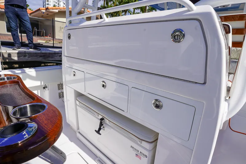 Slide: The Image of 2024 Invincible 43 Open Fisherman boat docked with triple outboard engines. - 11