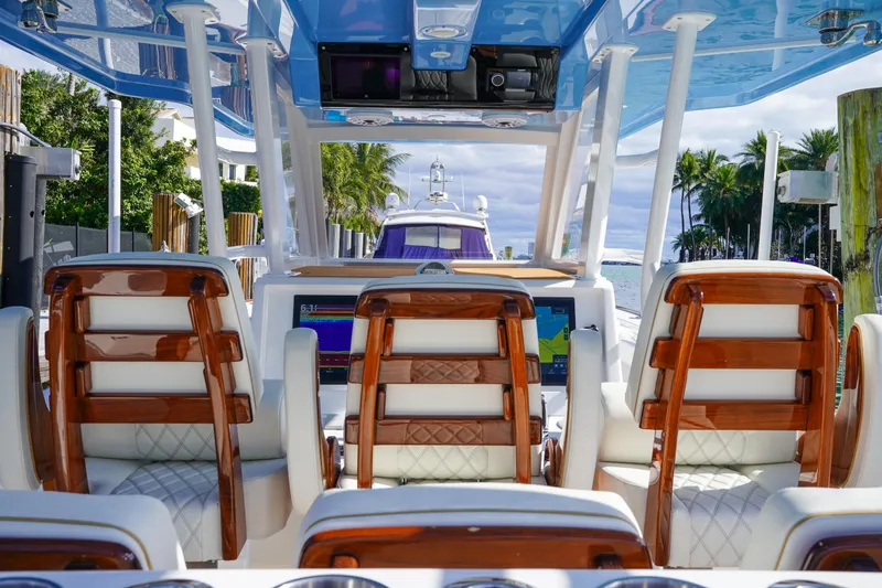 Slide: The Image of Aerial view of 2024 Invincible 43 Open Fisherman docked by a poolside. - 12