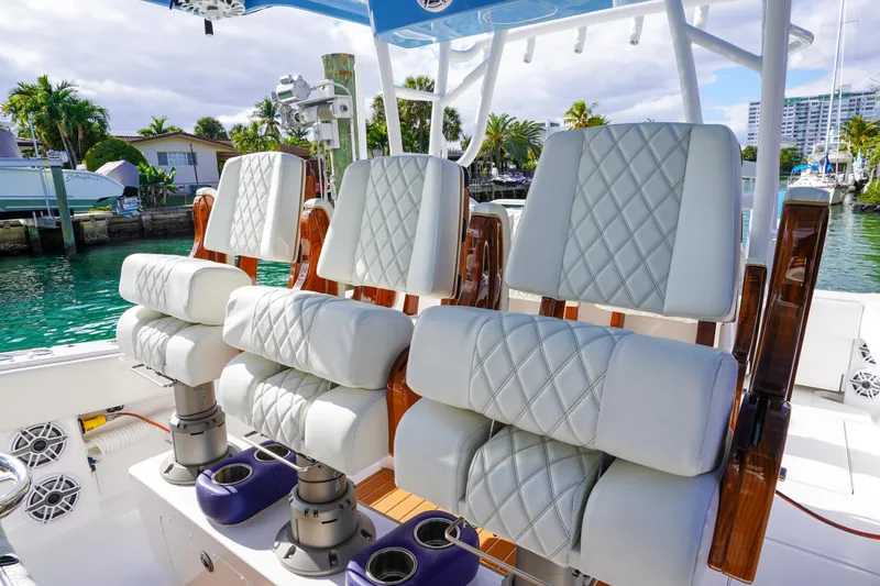 Slide: The Image of 2024 Invincible 43 Open Fisherman boat with Mercury engines, docked in a tropical setting. - 14