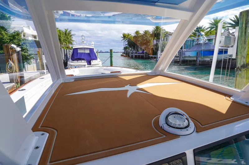 Slide: The Image of 2024 Invincible 43 Open Fisherman boat with Mercury engines, luxurious seating, and sleek design. - 21