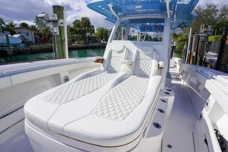 Slide: The Image of 2024 Invincible 43 Open Fisherman boat with luxurious seating and waterfront view. - 25