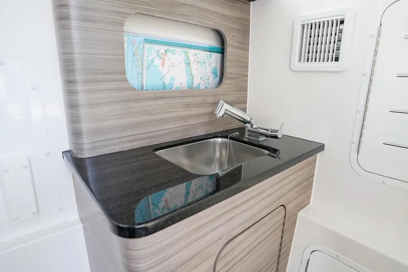 Slide: The Image of 2024 Invincible 43 Open Fisherman boat interior with modern electronics and speakers. - 30