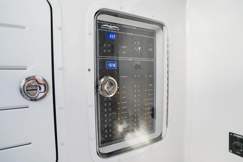 Slide: The Image of Control panel of 2024 Invincible 43 Open Fisherman boat, featuring digital displays and switches. - 44