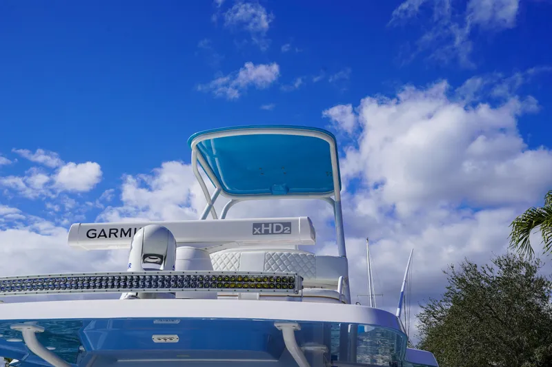 Slide: The Image of 2024 Invincible 43 Open Fisherman boat under a vibrant blue sky. - 51