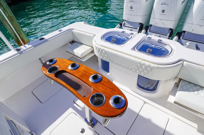 Slide: The Image of 2024 Invincible 43 Open Fisherman boat docked by a waterfront home. - 7