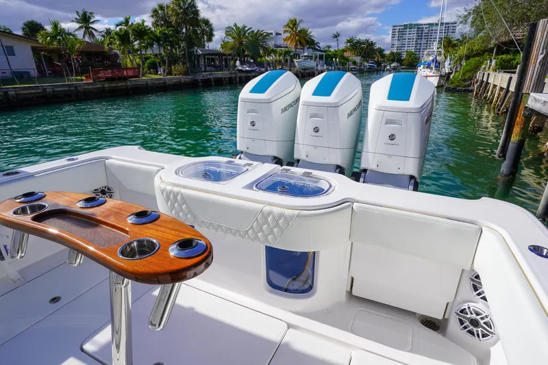 Slide: The Image of 2024 Invincible 43 Open Fisherman boat docked near a waterfront home. - 8