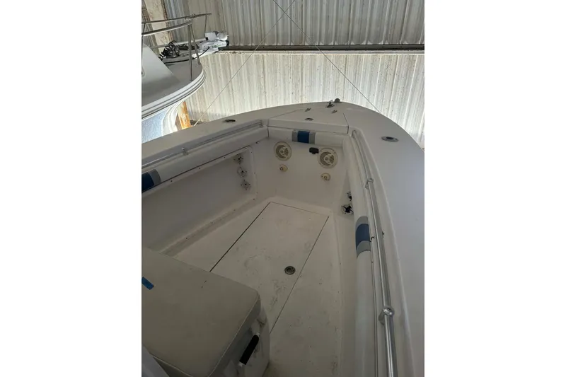 Slide: The Image of 2005 Contender 23 CC boat interior, featuring spacious deck and seating area. - 10