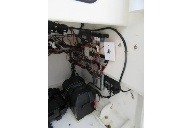 Slide: The Image of Electrical wiring and components inside a 2005 Contender 23 CC boat. - 14