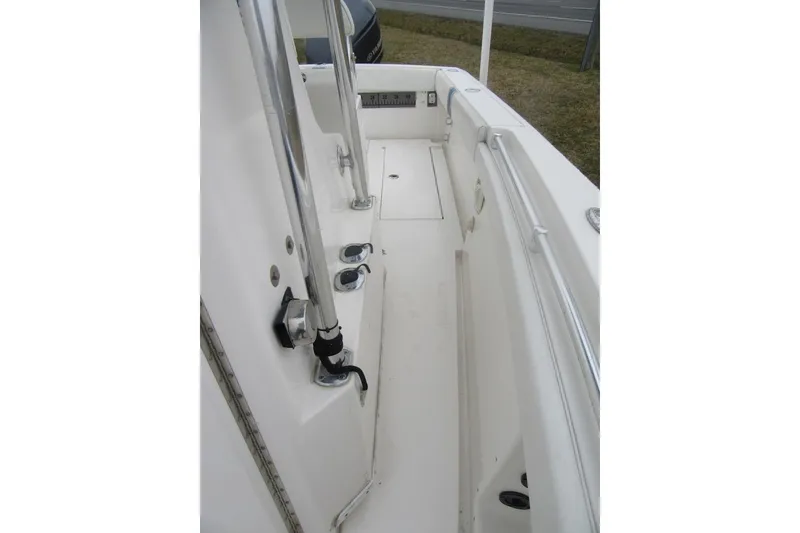 Slide: The Image of 2005 Contender 23 CC boat interior with clean white deck and stainless steel fittings. - 15