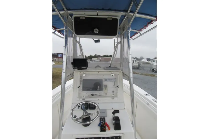 Slide: The Image of 2005 Contender 23 CC boat console with steering wheel and navigation equipment. - 17