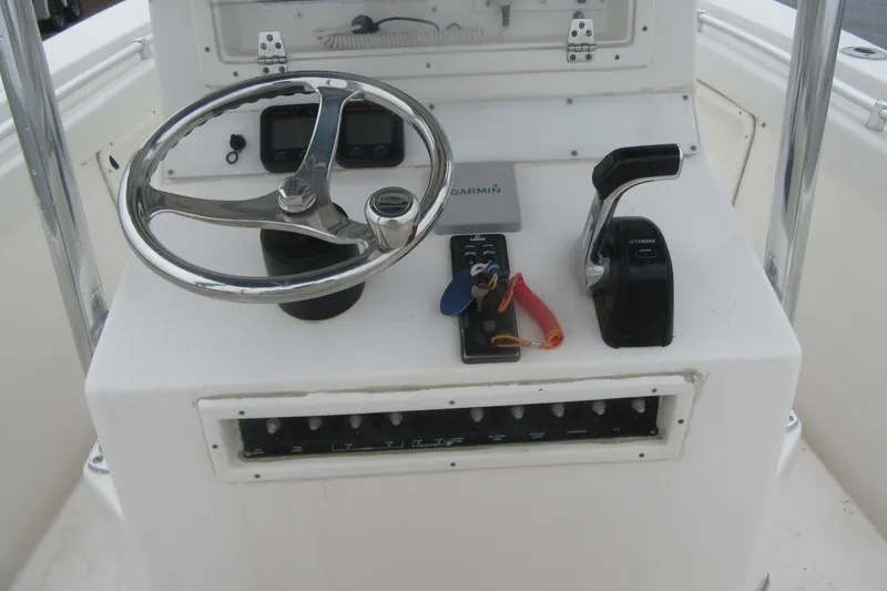 Slide: The Image of Center console of 2005 Contender 23 CC boat with steering wheel and controls. - 18