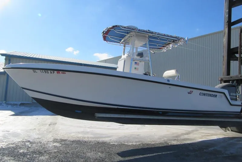 Slide: The Image of 2005 Contender 23 CC boat console with steering wheel and navigation equipment. - 2