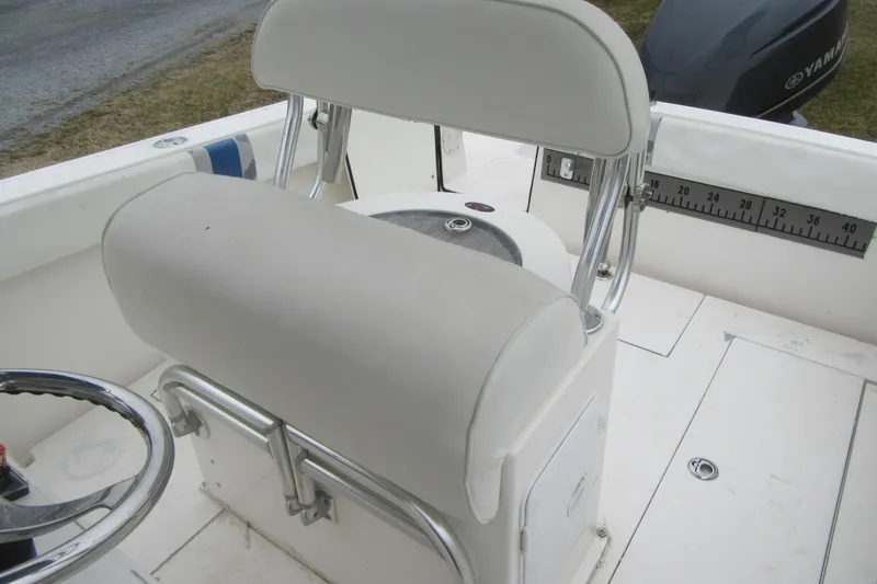 Slide: The Image of 2005 Contender 23 CC boat interior with steering wheel and cushioned seating. - 21