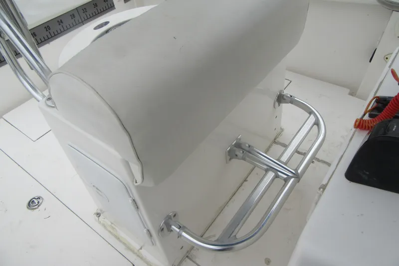 Slide: The Image of 2005 Contender 23 CC boat console with cushioned seat and stainless steel grab rail. - 22