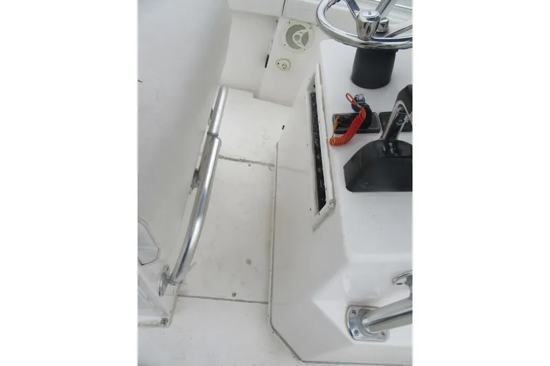 Slide: The Image of 2005 Contender 23 CC boat cockpit with steering wheel and controls. - 23