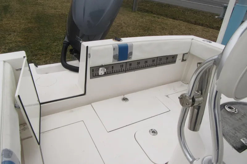 Slide: The Image of 2005 Contender 23 CC boat interior with measuring ruler and motor. - 24