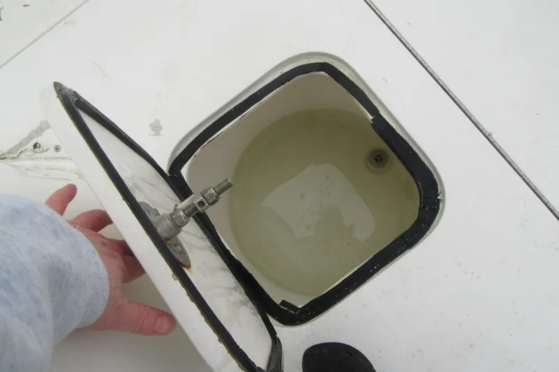 Slide: The Image of Open hatch on 2005 Contender 23 CC boat deck, showing interior compartment. - 29