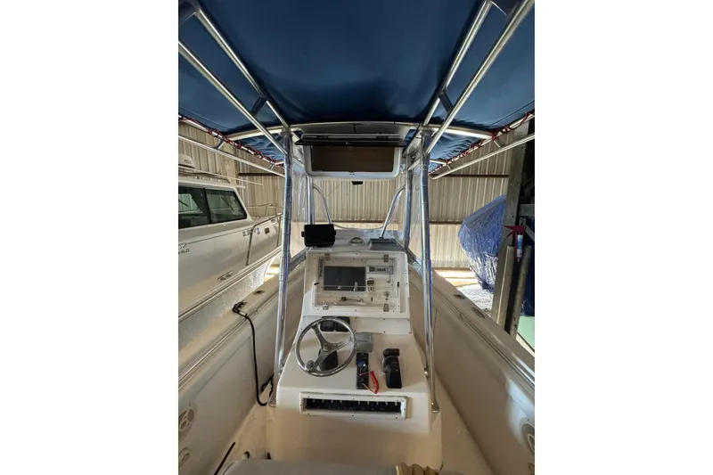 Slide: The Image of 2005 Contender 23 CC boat interior with steering wheel and navigation equipment. - 3