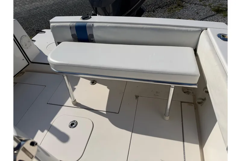Slide: The Image of White seating area on a 2005 Contender 23 CC boat deck. - 32