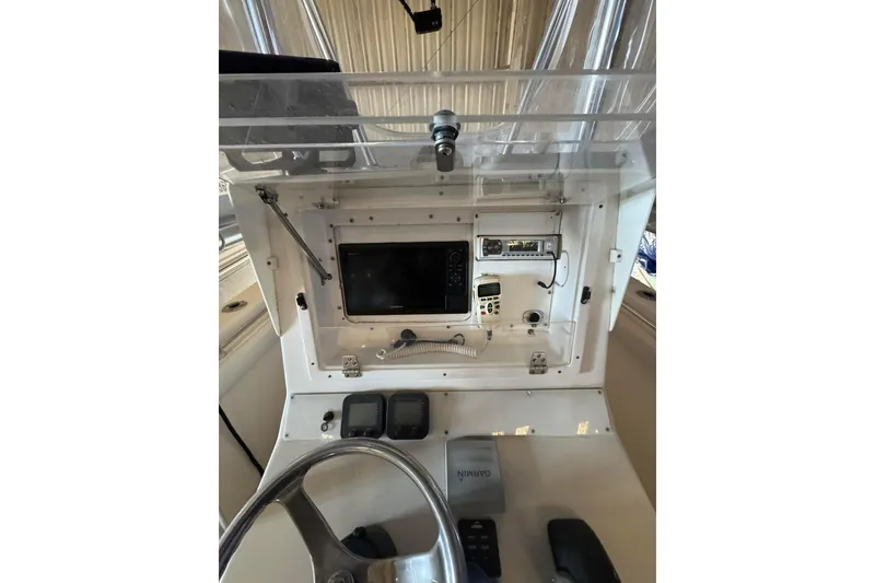 Slide: The Image of 2005 Contender 23 CC boat console with navigation equipment and steering wheel. - 5