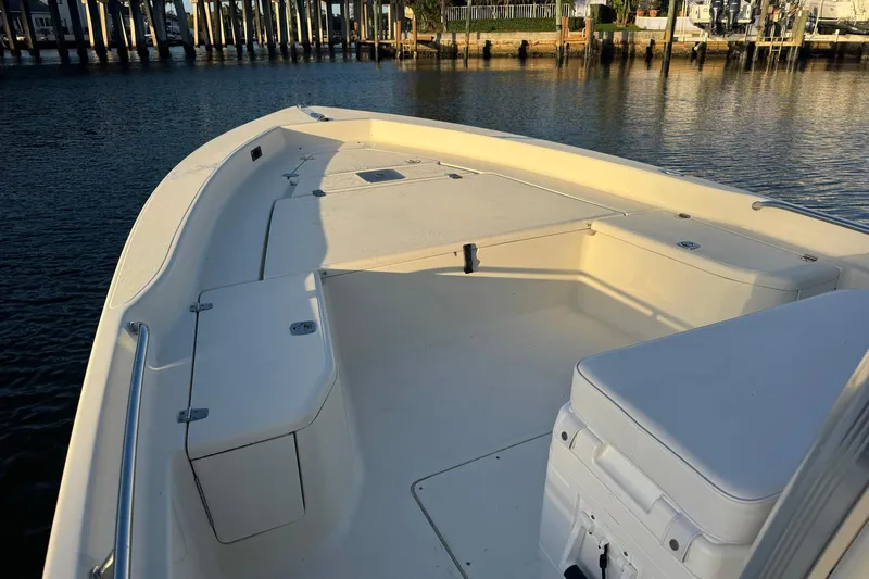 Slide: The Image of 2006 Scout 240 Bay Scout boat interior, spacious deck, calm waters, docked at marina. - 3