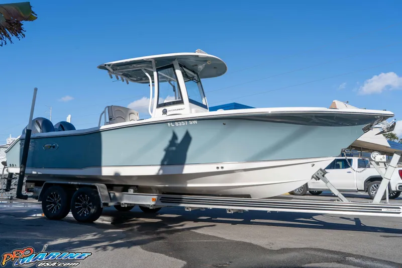Slide: The Image of 2021 Sea Hunt Ultra 265 SE boat on trailer under clear blue sky. - 12