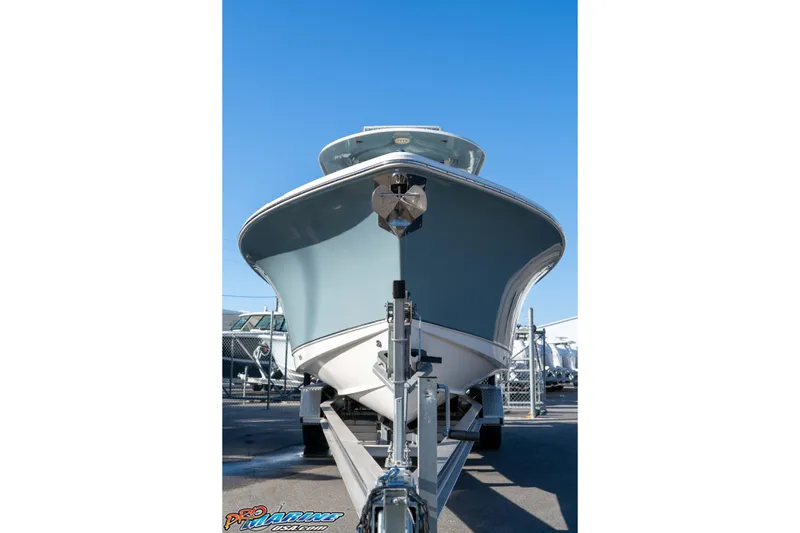 Slide: The Image of 2021 Sea Hunt Ultra 265 SE boat on trailer, viewed from front, under clear blue sky. - 13