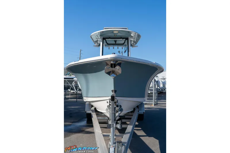 Slide: The Image of 2021 Sea Hunt Ultra 265 SE boat on trailer, front view, clear blue sky. - 14
