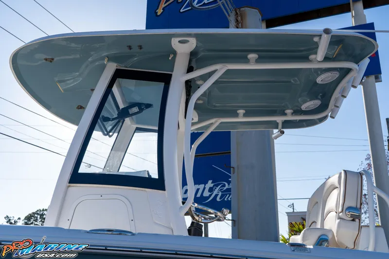 Slide: The Image of 2021 Sea Hunt Ultra 265 SE boat with T-top and seating, displayed outdoors. - 15