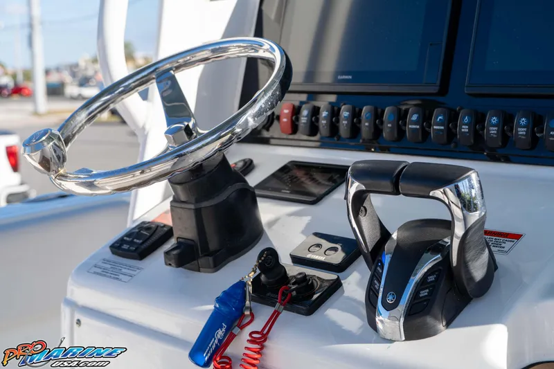 Slide: The Image of Steering console of 2021 Sea Hunt Ultra 265 SE boat with controls and displays. - 25