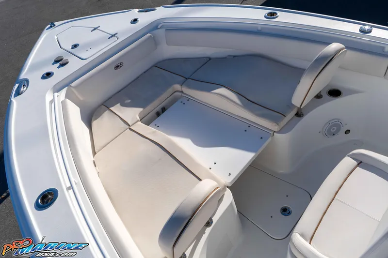 Slide: The Image of 2021 Sea Hunt Ultra 265 SE boat interior with cushioned seating and storage compartments. - 28