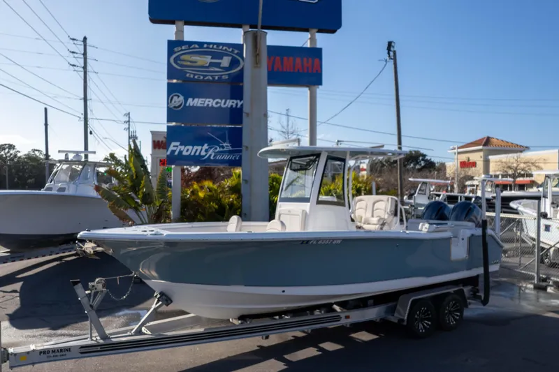 Slide: The Image of 2021 Sea Hunt Ultra 265 SE boat on trailer at dealership, sunny day. - 30