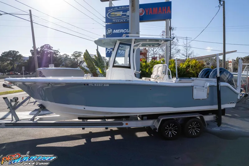 Slide: The Image of 2021 Sea Hunt Ultra 265 SE boat on trailer at dealership, sunny day. - 34