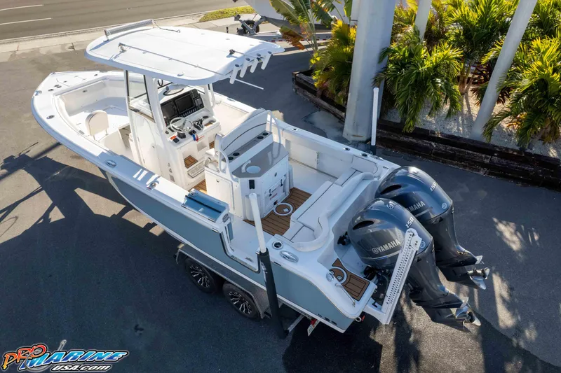 Slide: The Image of 2021 Sea Hunt Ultra 265 SE boat with dual Yamaha engines, parked on a trailer. - 39
