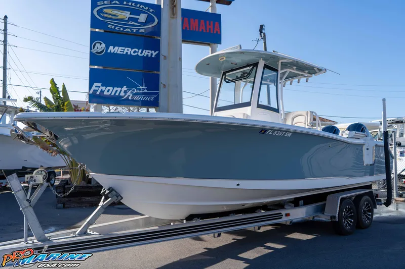 Slide: The Image of 2021 Sea Hunt Ultra 265 SE boat on trailer at dealership, featuring sleek design. - 4