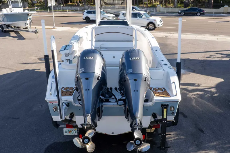 Slide: The Image of 2021 Sea Hunt Ultra 265 SE boat with dual 150 horsepower engines, parked on pavement. - 40